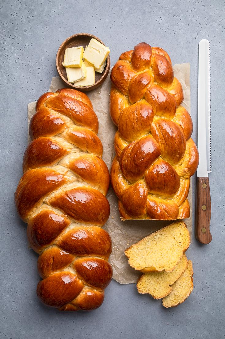  A beautifully braided vegan challah, ready to be sliced and enjoyed.