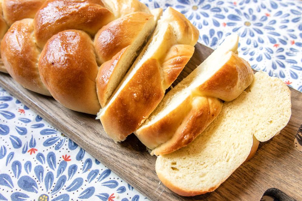  A slice of warm vegan challah slathered with vegan butter