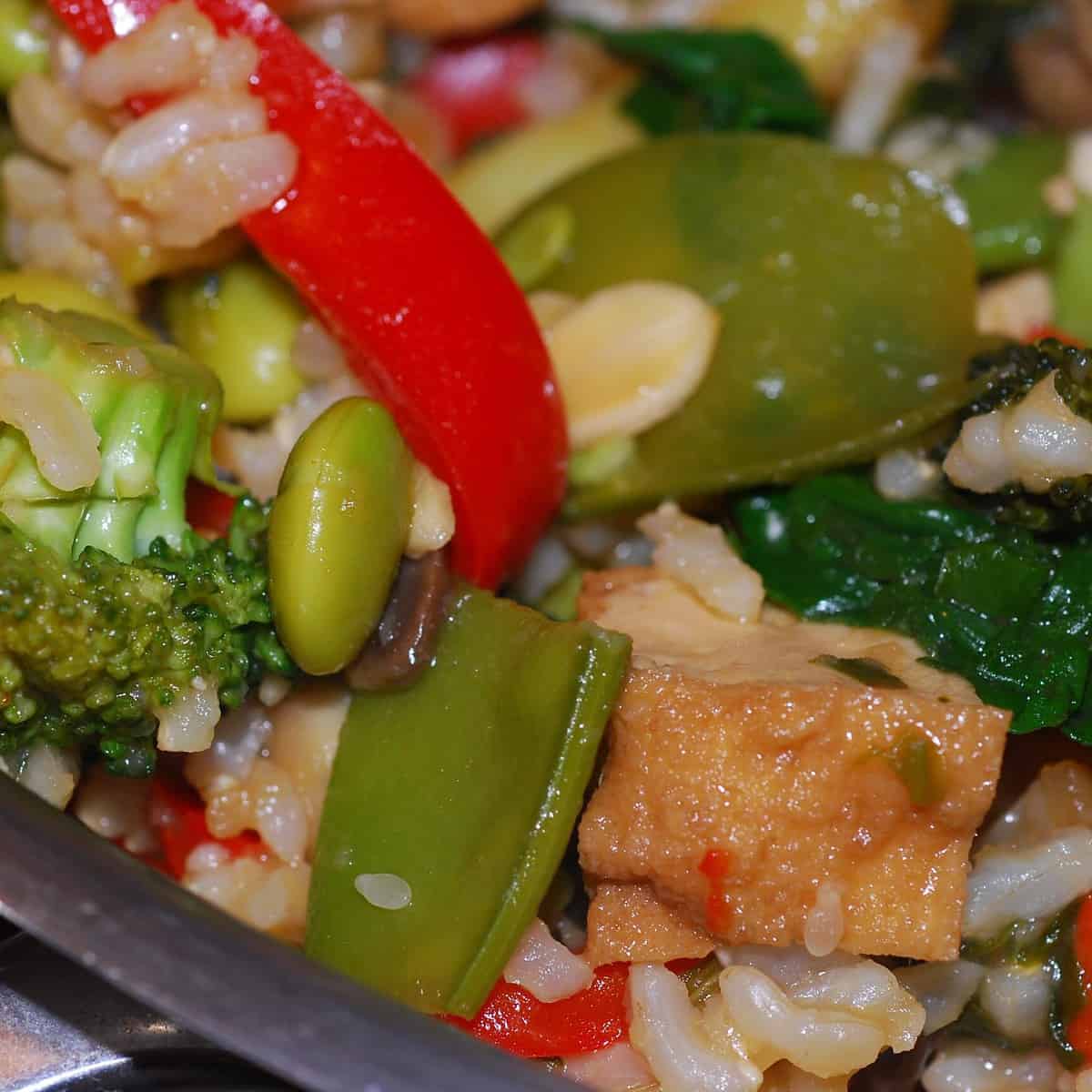 Colorful veggies collide in a bed of fluffy rice.