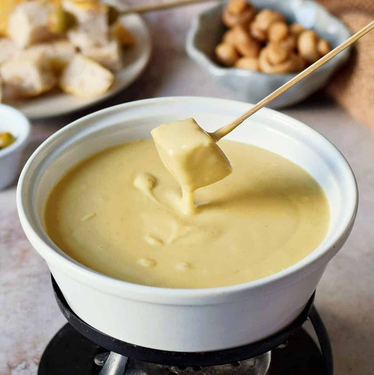  Melting Vegan Cheese creates a creamy base for this savory fondue.