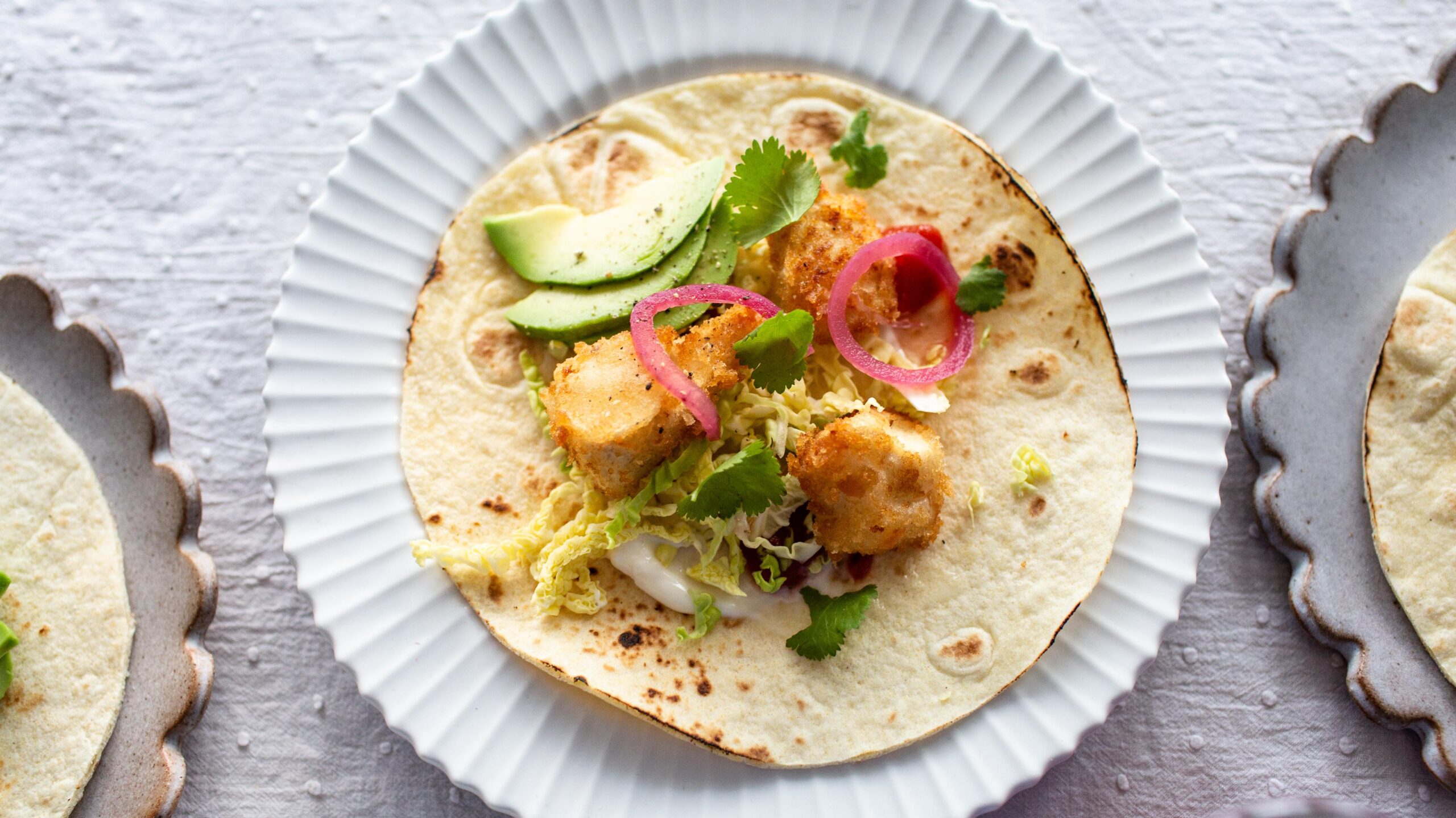  Pile up your tacos with tasty homemade guacamole, salsa and vegan 'fish'.